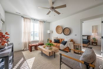a living room with a couch and a ceiling fan